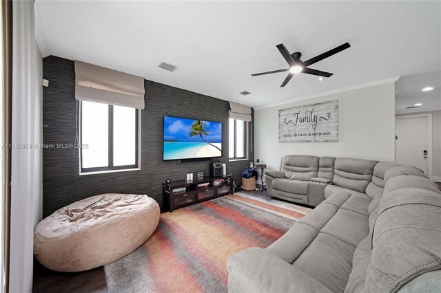 7567 SW 189th St, Cutler Bay, FL 33157 - living area featuring ceiling fan, an accent wall, recessed lighting, wood finished floors, and crown molding