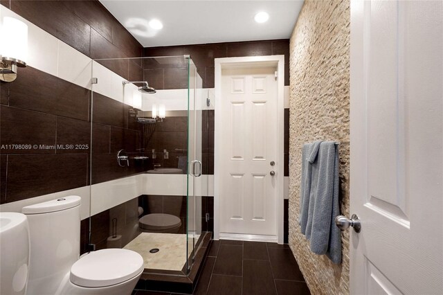 bathroom featuring toilet, a stall shower, recessed lighting, and tile patterned flooring