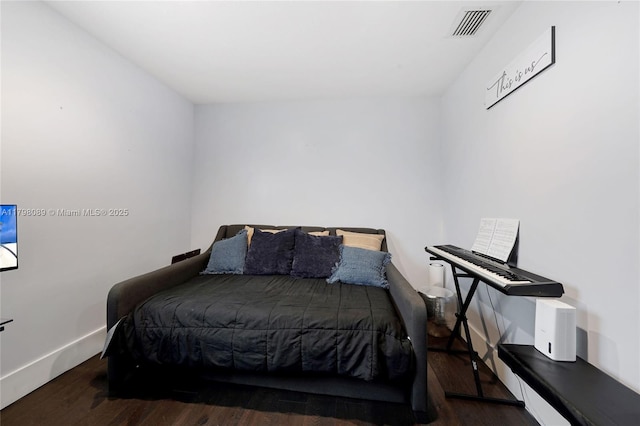 bedroom with wood finished floors and baseboards