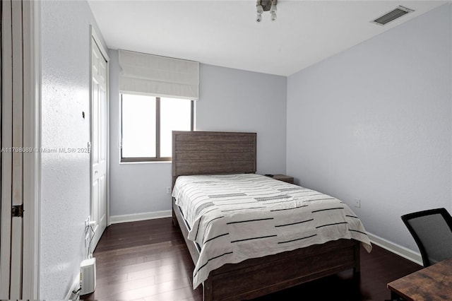 bedroom featuring wood finished floors and baseboards