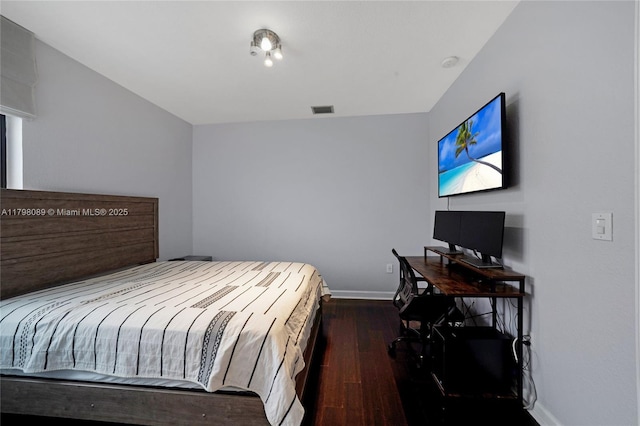 bedroom featuring hardwood / wood-style floors and baseboards