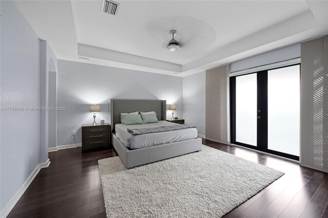 7567 SW 189th St, Cutler Bay, FL 33157 - bedroom featuring a raised ceiling, access to outside, dark wood-type flooring, baseboards, and french doors