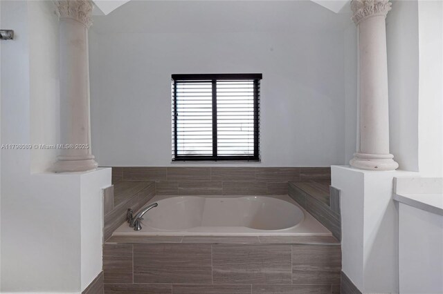 full bathroom with ornate columns and a garden tub