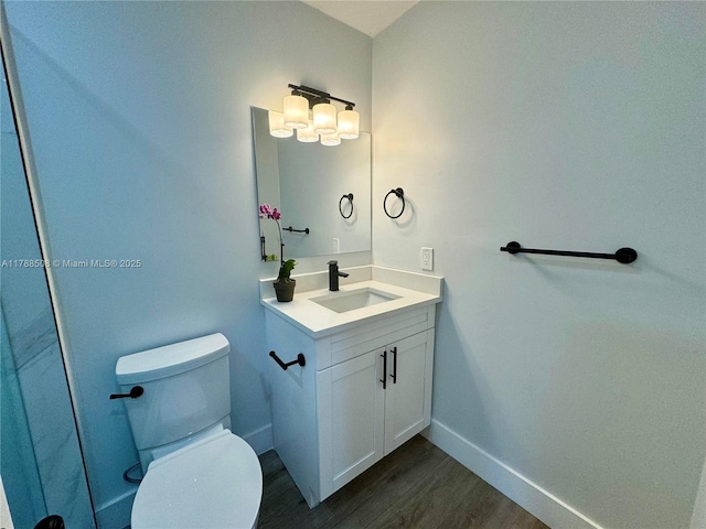 2631 SW 13th Ave, Fort Lauderdale, FL 33315 - bathroom with wood finished floors, toilet, vanity, and baseboards