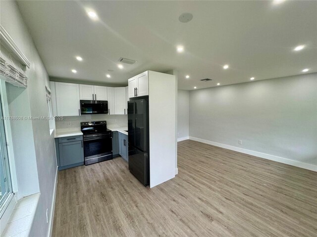 2631 SW 13th Ave, Fort Lauderdale, FL 33315 - kitchen featuring black appliances, light wood finished floors, light countertops, baseboards, and open floor plan