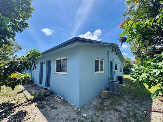 2631 SW 13th Ave, Fort Lauderdale, FL 33315 - view of side of home with stucco siding and central air condition unit