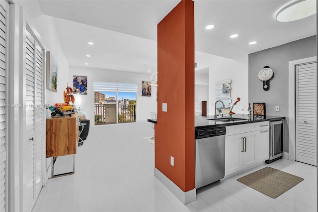 2650 SW 37th Ave Unit 906, Miami, FL 33133 - kitchen featuring stainless steel dishwasher, a sink, beverage cooler, dark countertops, and recessed lighting