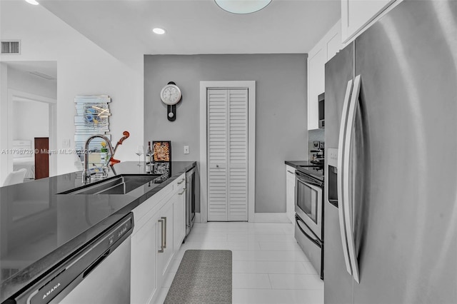 2650 SW 37th Ave Unit 906, Miami, FL 33133 - kitchen with appliances with stainless steel finishes, a sink, white cabinetry, recessed lighting, and light tile patterned floors