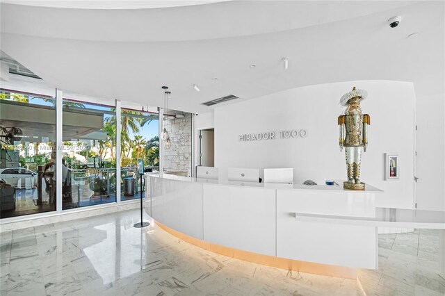1000 W Ave Unit 308, Miami Beach, FL 33139 - reception area with a surveillance system and floor to ceiling windows