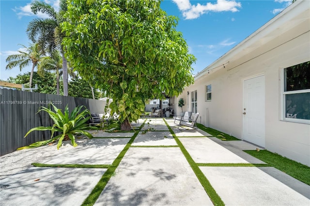 fenced yard featuring a patio area