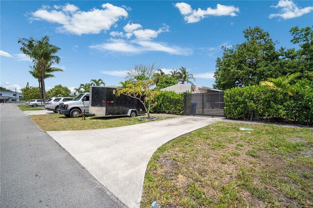 1245 NE 154th St, North Miami Beach, FL 33162 - view of front of house with driveway and fence