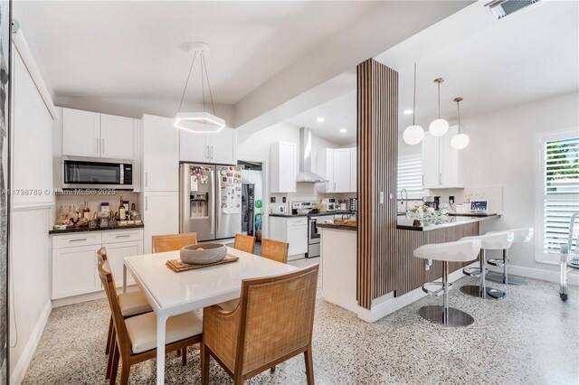 1245 NE 154th St, North Miami Beach, FL 33162 - dining room with dark aggregate flooring, baseboards, and recessed lighting