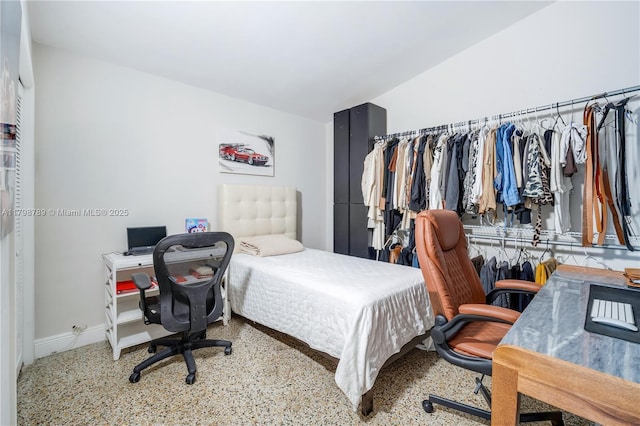 bedroom with a desk and baseboards