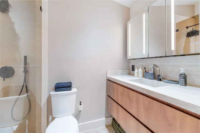 bathroom featuring tasteful backsplash, a shower, vanity, and baseboards