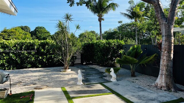 1245 NE 154th St, North Miami Beach, FL 33162 - rear view of property featuring stucco siding and a patio