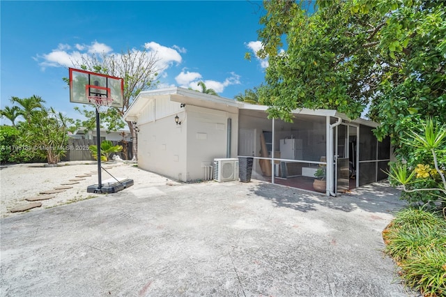 back of property with a patio, ac unit, and a sunroom