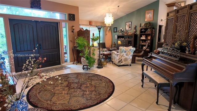 tiled foyer with a chandelier and vaulted ceiling