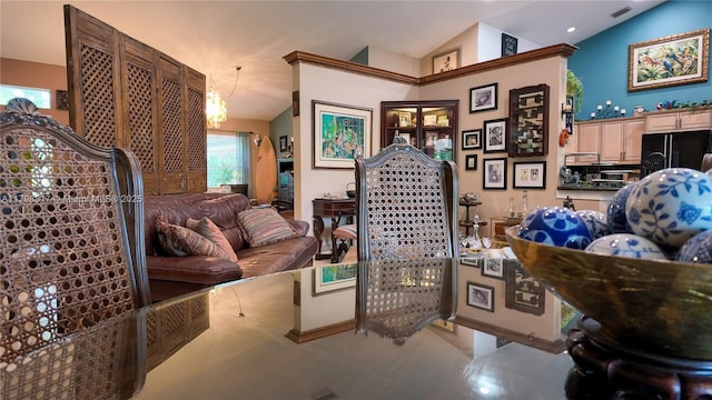 living area with vaulted ceiling and a chandelier