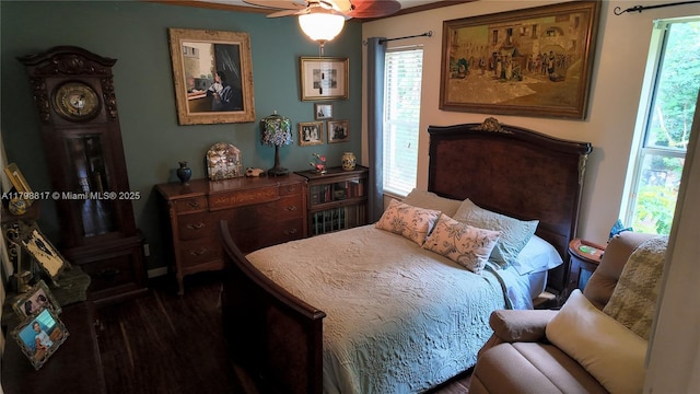 bedroom featuring dark wood-style flooring and baseboards