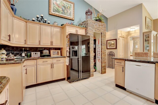 95 E Westwood Cir E, West Palm Beach, FL 33411 - kitchen with dishwasher, black fridge, dark stone countertops, high vaulted ceiling, and decorative backsplash