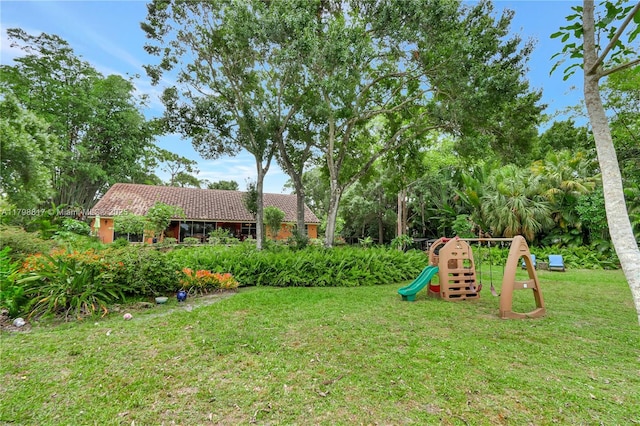95 E Westwood Cir E, West Palm Beach, FL 33411 - view of green lawn featuring a playground