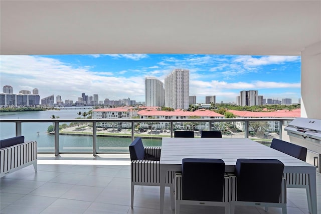 balcony with a skyline view and a water view
