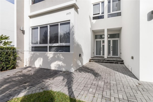 2475 NE 135th St, North Miami, FL 33181 - doorway to property with stucco siding