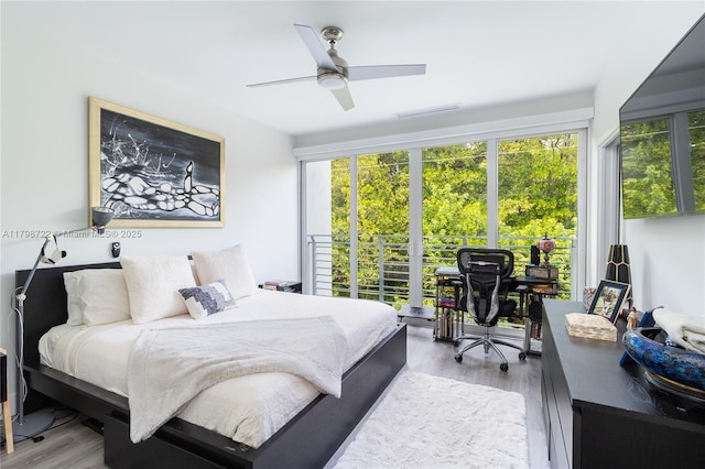 2475 NE 135th St, North Miami, FL 33181 - bedroom featuring an office area, light wood-style floors, and a ceiling fan