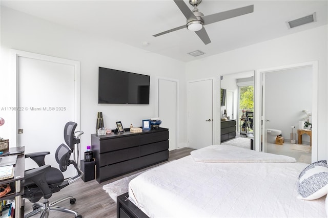 2475 NE 135th St, North Miami, FL 33181 - bedroom featuring an office area, wood finished floors, ceiling fan, and ensuite bathroom