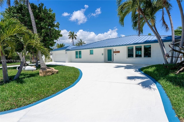 2711 NE 57th Ct, Fort Lauderdale, FL 33308 - single story home featuring curved driveway, stucco siding, a standing seam roof, a garage, and metal roof