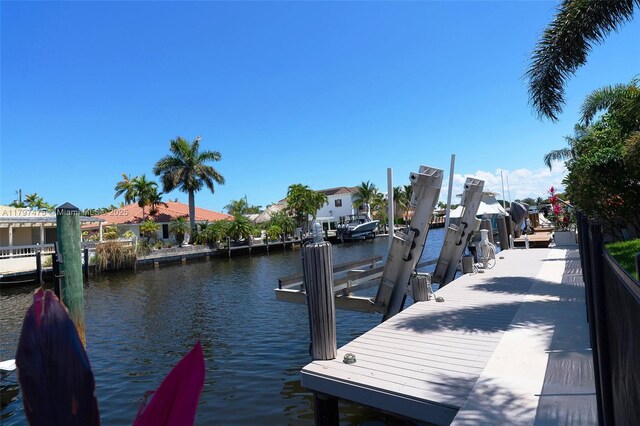 2711 NE 57th Ct, Fort Lauderdale, FL 33308 - dock area featuring boat lift, a water view, and a residential view