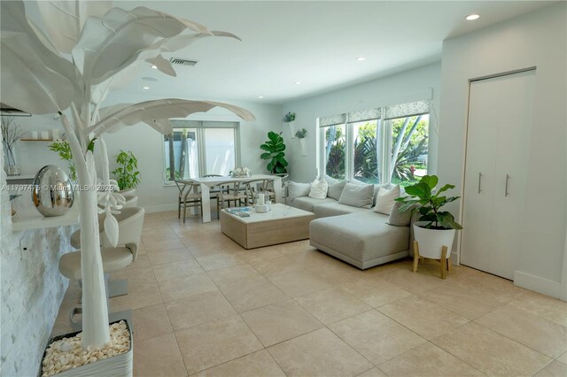 2711 NE 57th Ct, Fort Lauderdale, FL 33308 - living area with plenty of natural light, light tile patterned floors, recessed lighting, arched walkways, and baseboards