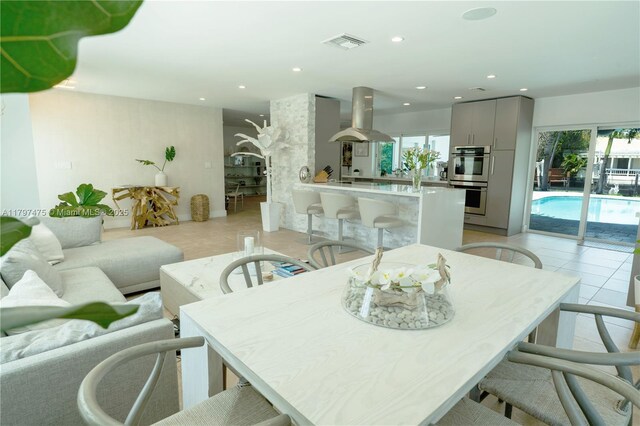 2711 NE 57th Ct, Fort Lauderdale, FL 33308 - dining space featuring light tile patterned flooring and recessed lighting