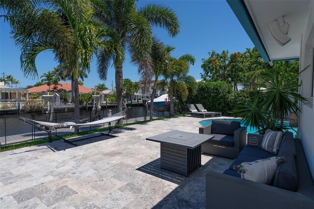 2711 NE 57th Ct, Fort Lauderdale, FL 33308 - view of patio / terrace with a water view, an outdoor hangout area, and a boat dock