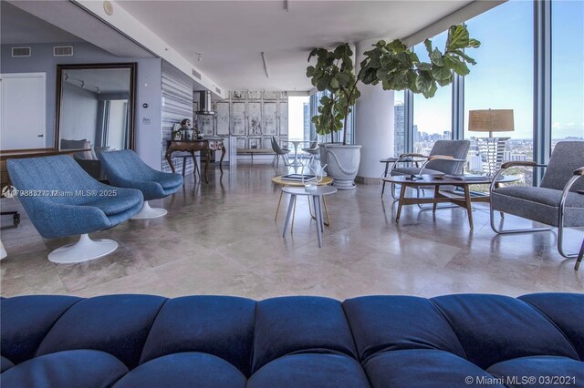601 NE 36th St Unit 3101, Miami, FL 33137 - living area with concrete flooring and a wall of windows