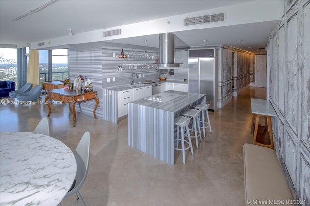 601 NE 36th St Unit 3101, Miami, FL 33137 - kitchen with range hood, white cabinetry, a sink, stainless steel appliances, and light countertops