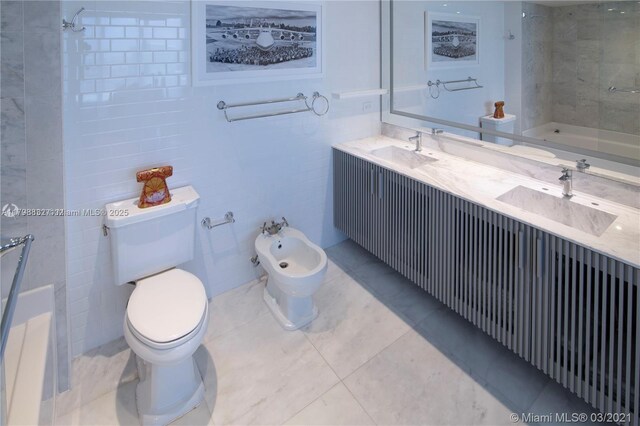 601 NE 36th St Unit 3101, Miami, FL 33137 - bathroom with tile walls, toilet, double vanity, tile patterned flooring, and a bidet