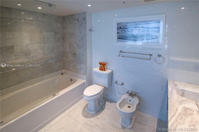 601 NE 36th St Unit 3101, Miami, FL 33137 - bathroom featuring toilet, tile walls, washtub / shower combination, a bidet, and tile patterned flooring