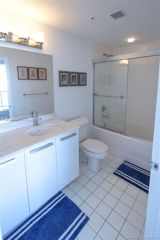 601 NE 36th St Unit 3101, Miami, FL 33137 - full bath with tile patterned flooring, vanity, shower / bath combination with glass door, and toilet