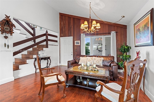 3865 NW 1st Pl, Deerfield Beach, FL 33442 - living room featuring lofted ceiling, wood walls, stairway, wood finished floors, and a chandelier