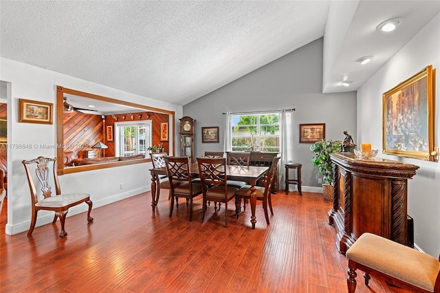 3865 NW 1st Pl, Deerfield Beach, FL 33442 - dining room featuring wood finished floors, lofted ceiling, baseboards, and a textured ceiling