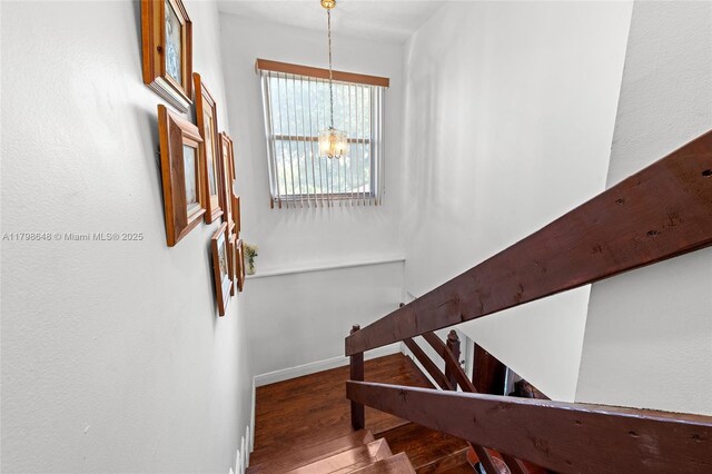 3865 NW 1st Pl, Deerfield Beach, FL 33442 - stairway with a chandelier, wood finished floors, and baseboards