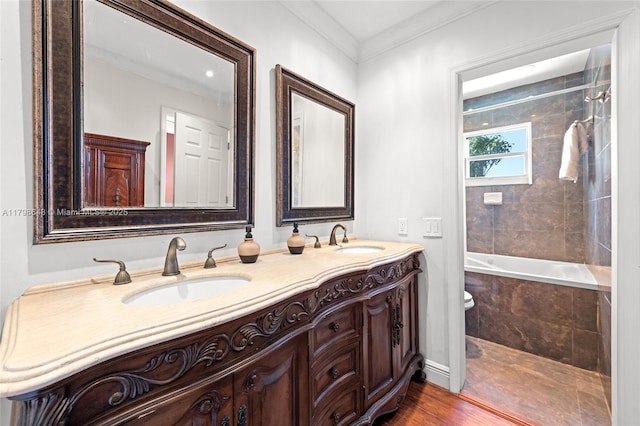 3865 NW 1st Pl, Deerfield Beach, FL 33442 - bathroom with double vanity, crown molding, tiled shower / bath, wood finished floors, and toilet