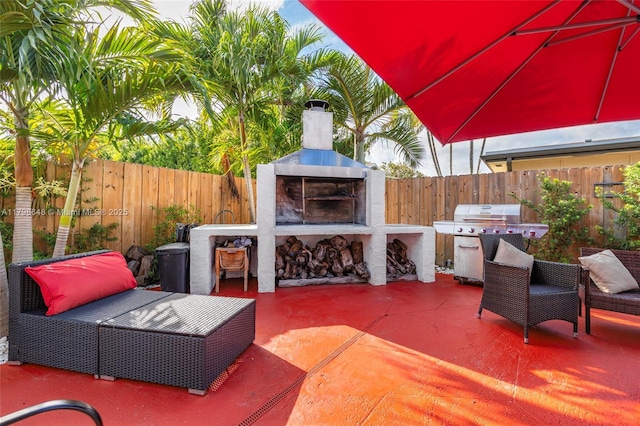 3865 NW 1st Pl, Deerfield Beach, FL 33442 - view of patio / terrace featuring grilling area, a fenced backyard, and an outdoor living space with a fireplace