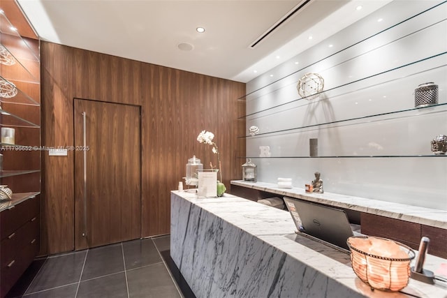welcome area featuring wooden walls and built in study area