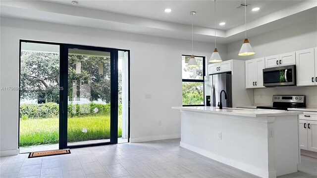 2615 68th St W, Lehigh Acres, FL 33971 - kitchen with stainless steel appliances, baseboards, plenty of natural light, a sink, and recessed lighting
