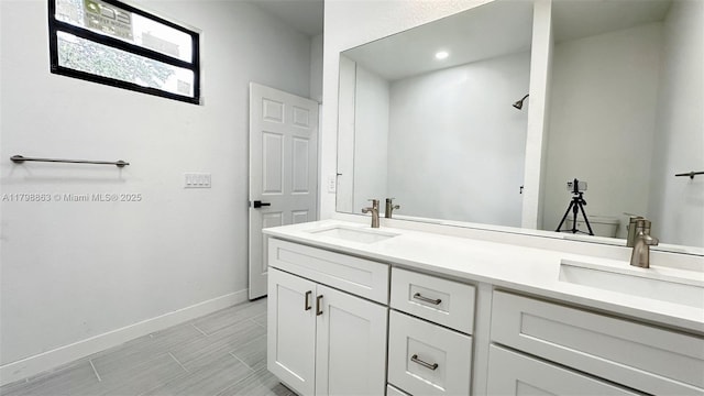 2615 68th St W, Lehigh Acres, FL 33971 - bathroom featuring baseboards, double vanity, and recessed lighting