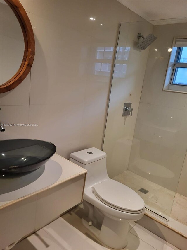 bathroom featuring walk in shower, a sink, and toilet