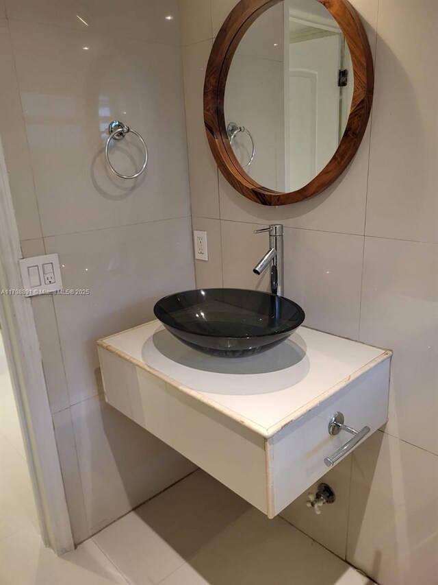 bathroom with tile walls and vanity