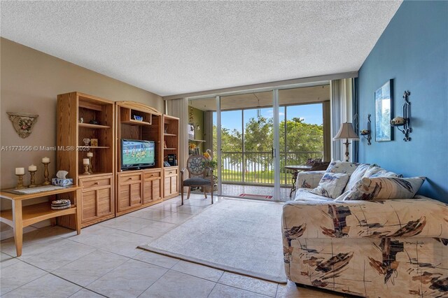 922 NE 199th St Unit 206, Miami, FL 33179 - tiled living room featuring a textured ceiling